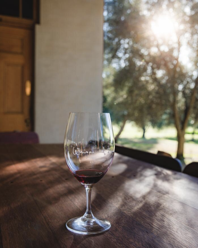 Whispering Brook wine glass on a table